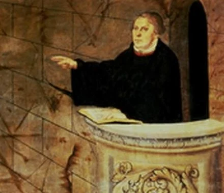 Luther preaches without a gesture of his own: one hand rests on the Scripture, the other points away from himself.