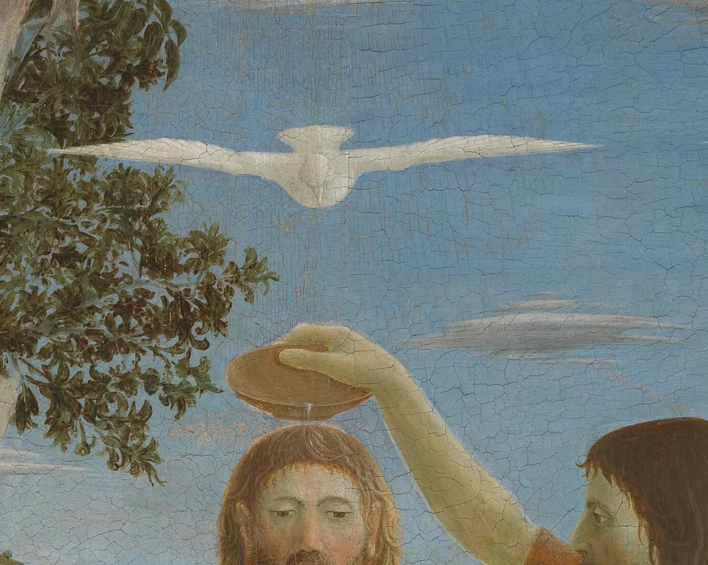 The dove is seen from the front, with spread wings, and looks like one of the clouds.