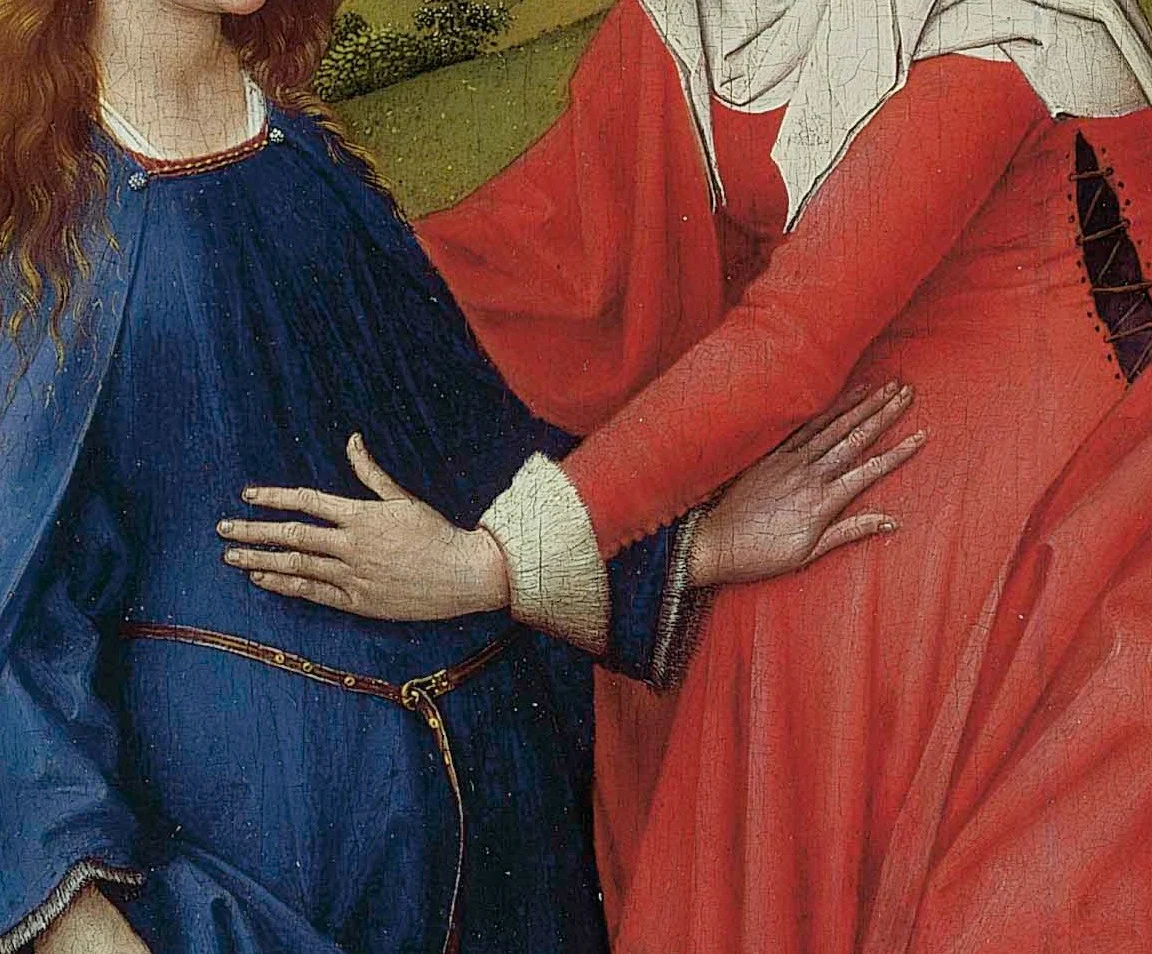 The two hands: each woman feels for the other's child.