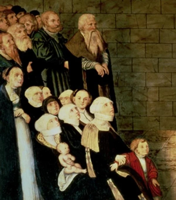 The congregation: men standing, women and children seated. Tradition sees Luther's wife Katharina and his son Hans among them, and the old Cranach with his long beard.