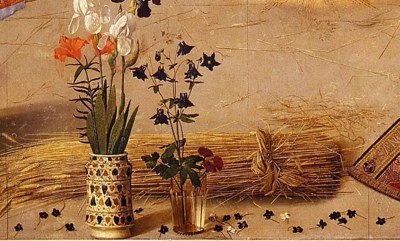 A sheaf of wheat lies on the ground: Bethlehem means house of bread, and the wheat points to the bread of the Eucharist. In the vases stand lilies, irises and columbines.