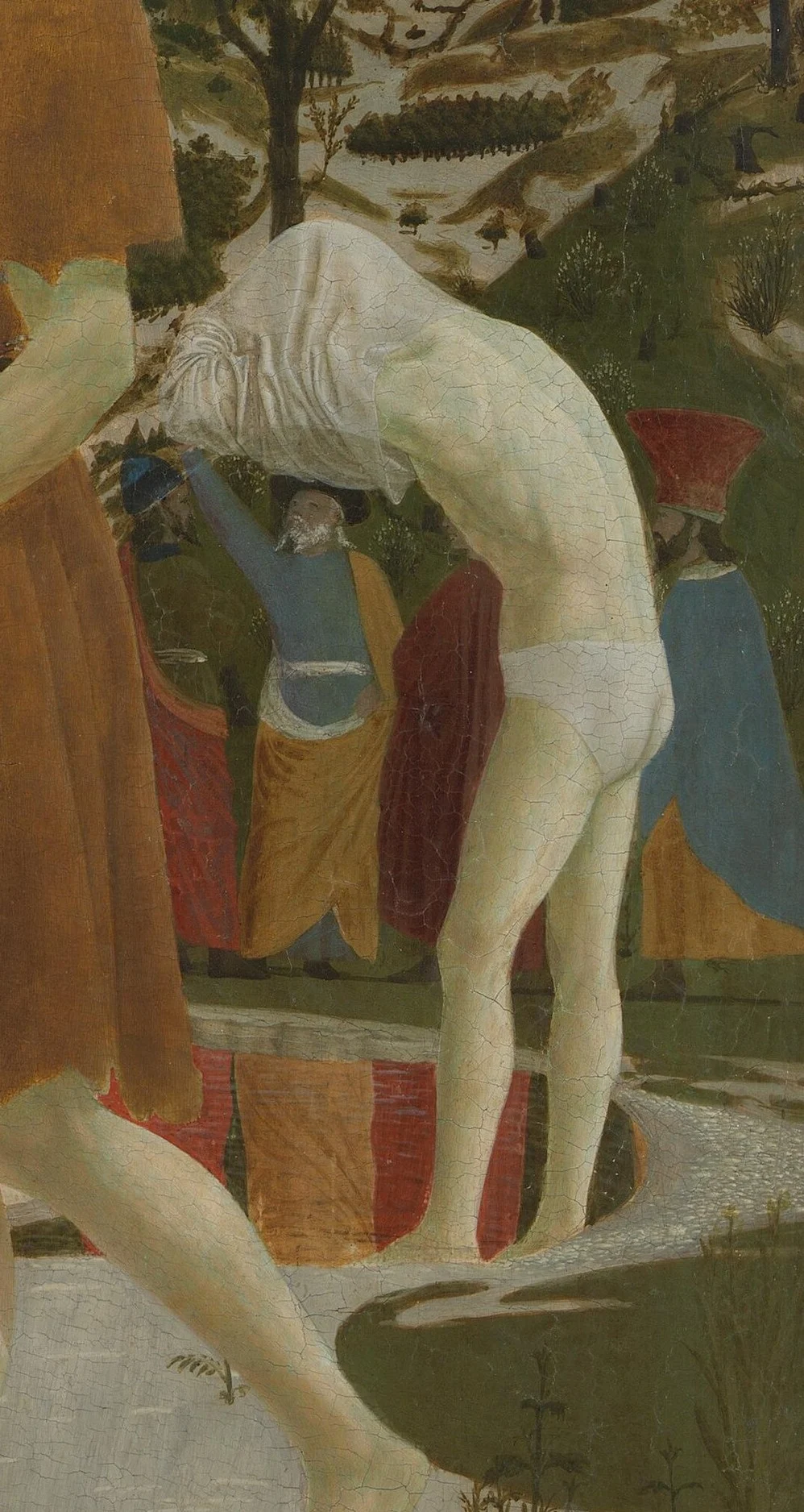 The next one to be baptised is already undressing.