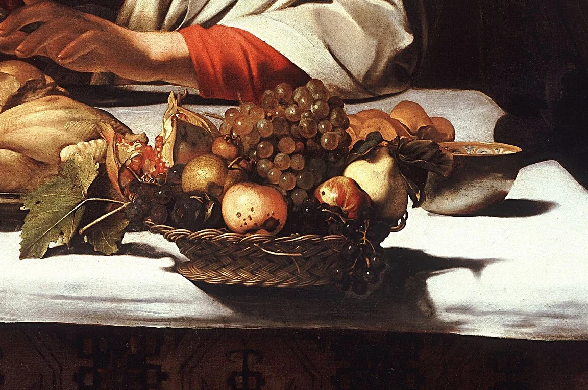 The basket stands half over the edge of the table and seems about to fall into our space. The fruit is autumn fruit, though Easter is in spring.