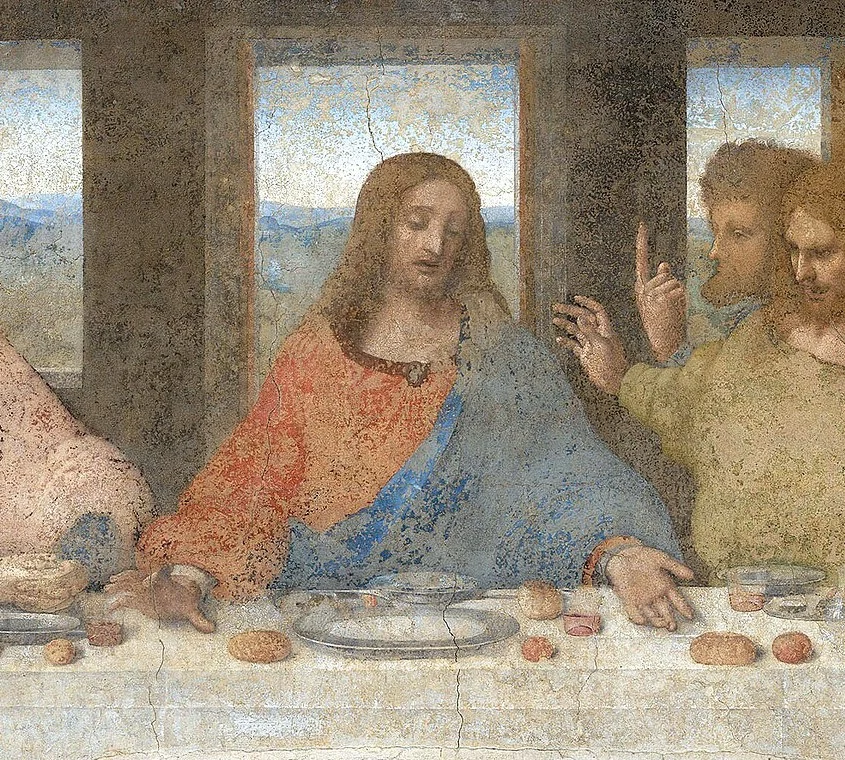 Christ's hands point to bread and wine. All the lines of the room meet at his head.