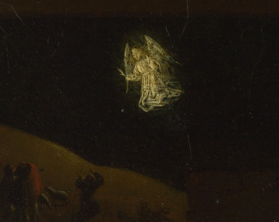 On the hill behind, the angel appears to the shepherds.