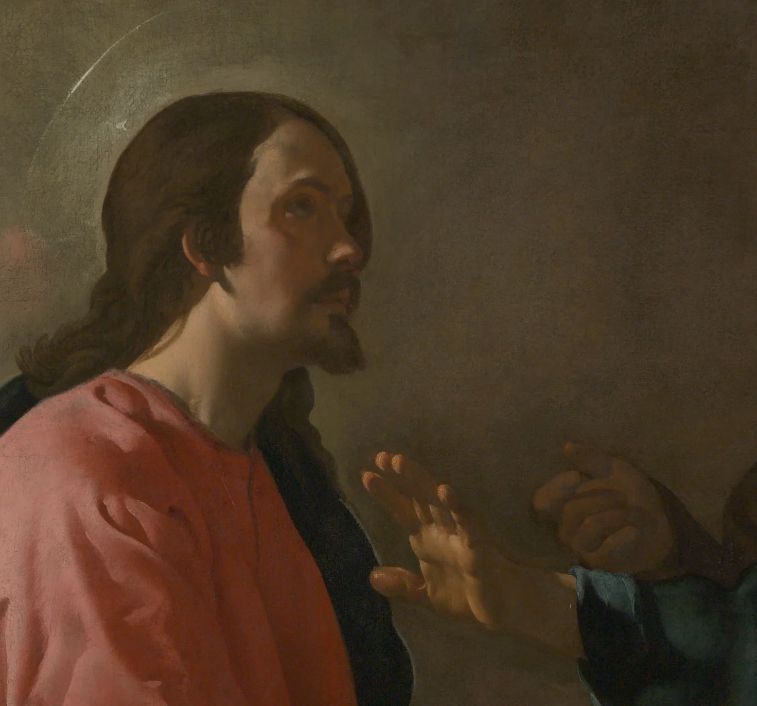 A thin ring of light round the head is all that marks Christ out. The disciple's hand is raised between them.
