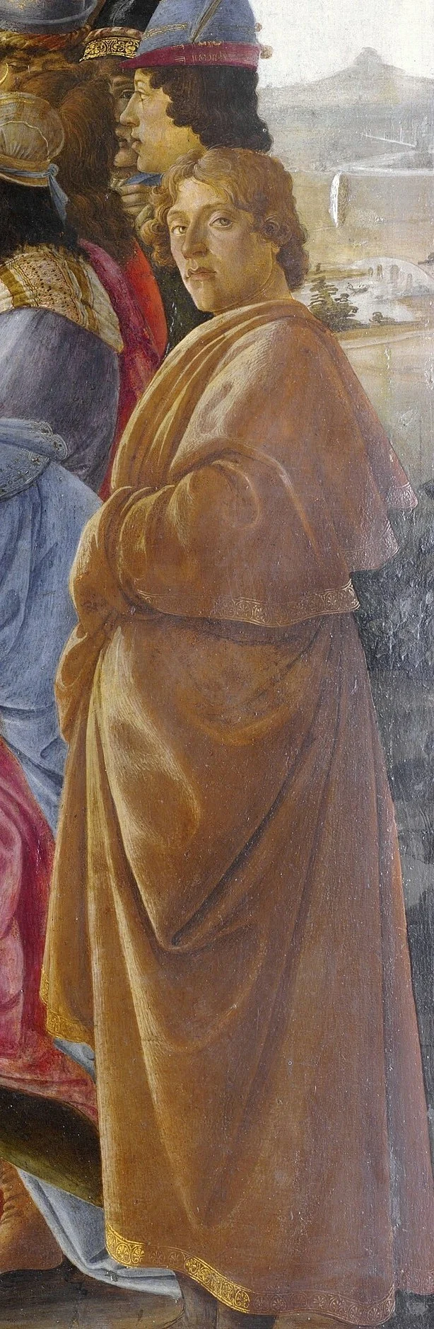 Der junge Mann im gelben Mantel am Rand sieht uns gerade an. Er gilt als Botticelli selbst.