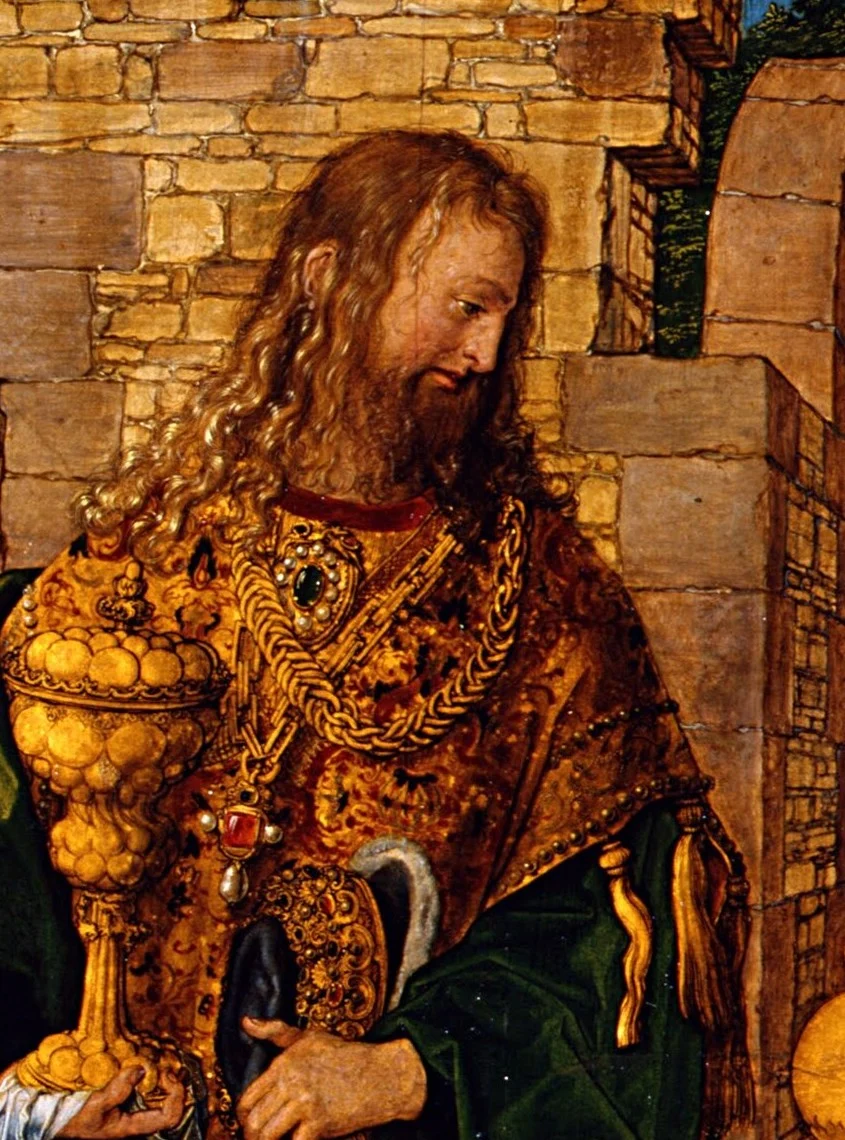 The king with the long curls and the golden goblet has Dürer's own features.