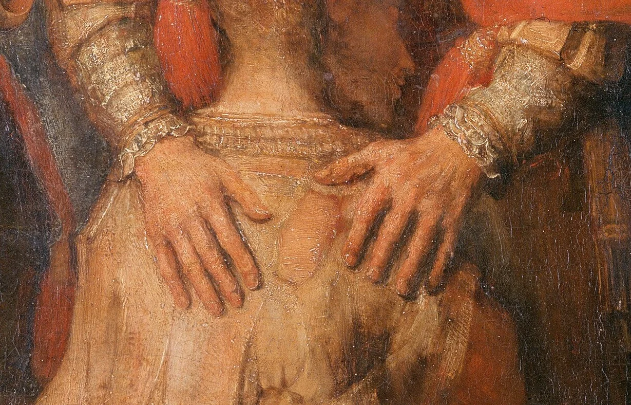 The two hands of the father lie flat on the son's back. Much has been written about the fact that they look different, one broader, one narrower.